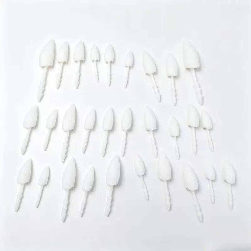 Halloween Pumpkin Teeth Inserts sharp fangs in assorted sizes arranged on a white background