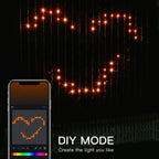 Halloween Smart Curtain Lights DIY app screen beside an orange smiling-face pattern on the hanging light strands