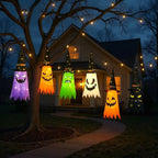 Halloween Witch Hat Lanterns six-color set hanging from a tree in a front-yard Halloween display