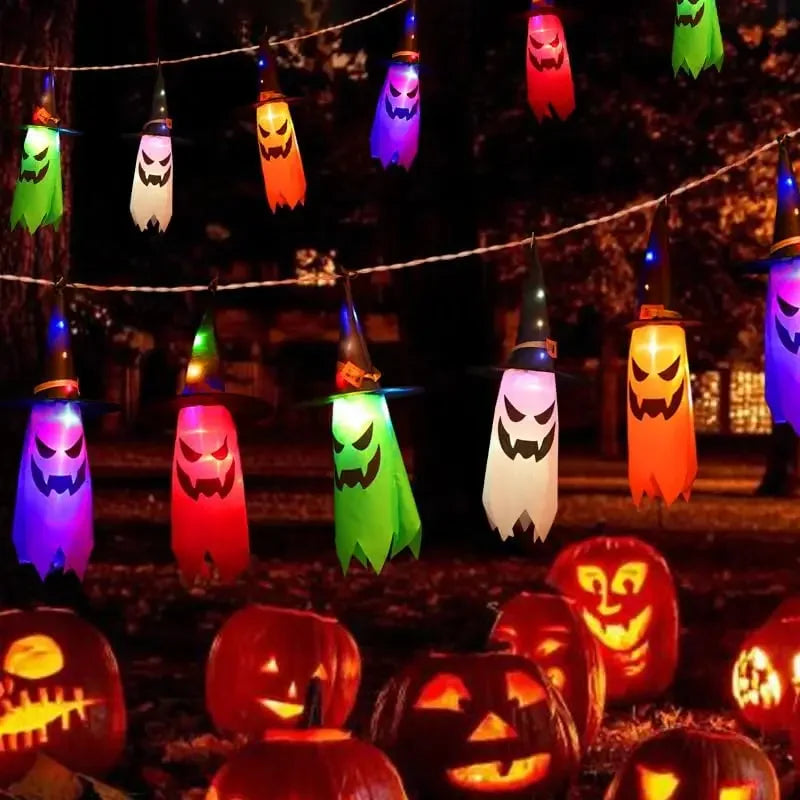 Halloween Witch Hat Lanterns glowing above pumpkins in a colorful outdoor Halloween party scene