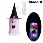 Halloween Witch Hat Lanterns in pink, shown unlit and glowing with a spooky character face