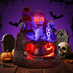 Haunted Halloween Train Village at HighPeak glowing on a tabletop surrounded by pumpkins, skulls, and tombstones.