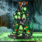 Haunted Treehouse Building Set glowing green on a wooden tabletop with mist and Halloween bunting behind it.