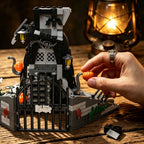 Haunted Treehouse Building Set assembly close-up with a hand attaching an orange pumpkin beside the courtyard gate.
