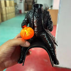 Headless Rider Cat Costume held in a hand, showing the glowing orange pumpkin and black rider from the front.