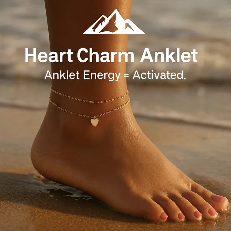 HighPeak Heart Charm Anklet in delicate gold with a small heart charm worn on a sunlit beach shore