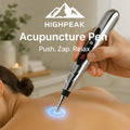 HighPeak Acupuncture Pen in silver handheld for pain relief on a person’s back with glowing electrode tip active