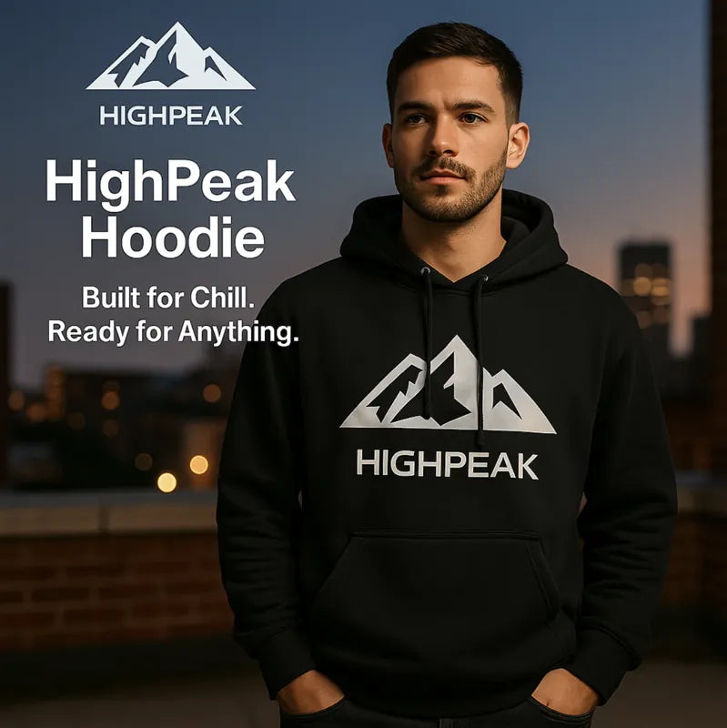 HighPeak Hoodie in black with iconic mountain logo worn by man at dusk, showcasing cozy style and versatile cold-weather wear.
