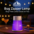 HighPeak Bug Zapper Lamp in white with purple UV light on outdoor table trapping insects silently at night