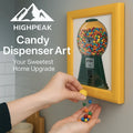 HighPeak Candy Dispenser Art in yellow frame wall-mounted with colorful gumballs dispensing into hands in kitchen setting