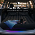 HighPeak Car Air Mattress with Pump inflated in black inside SUV trunk with blanket and mug for road trip comfort