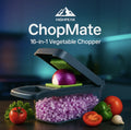 HighPeak ChopMate™ 16-in-1 Vegetable Chopper in black dicing onions with fresh vegetables nearby on a kitchen counter