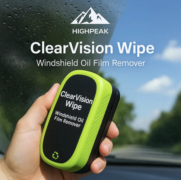 HighPeak ClearVision™ Windshield Oil Film Remover in green and black held against a car windshield outdoors.