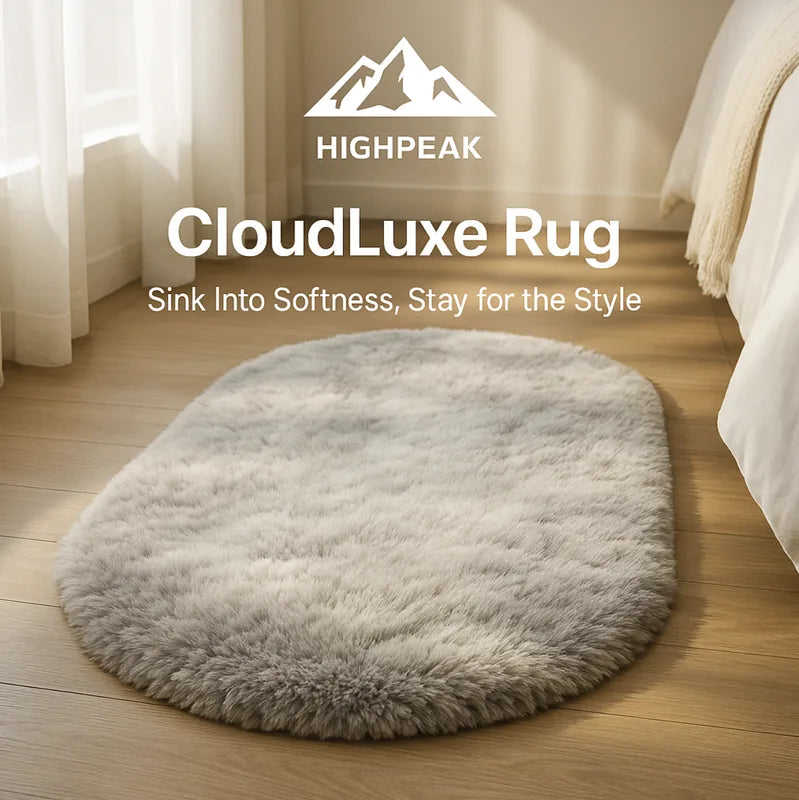 HighPeak CloudLuxe™ Ultra Soft Rug in neutral gray oval shape on wooden floor by bed with natural light