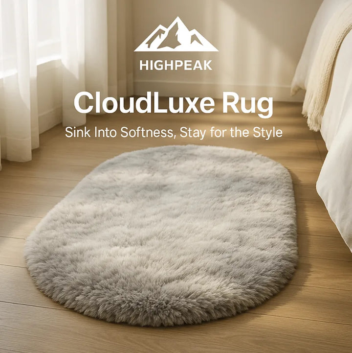 HighPeak CloudLuxe™ Ultra Soft Rug in neutral gray oval shape on wooden floor by bed with natural light