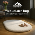 HighPeak CloudLuxe™ Ultra Soft Rug in white oval shape on wood floor with beige slippers in cozy room setting