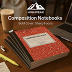 HighPeak Composition Notebooks 4-Pack with classic red cover stacked on a desk next to laptop and coffee