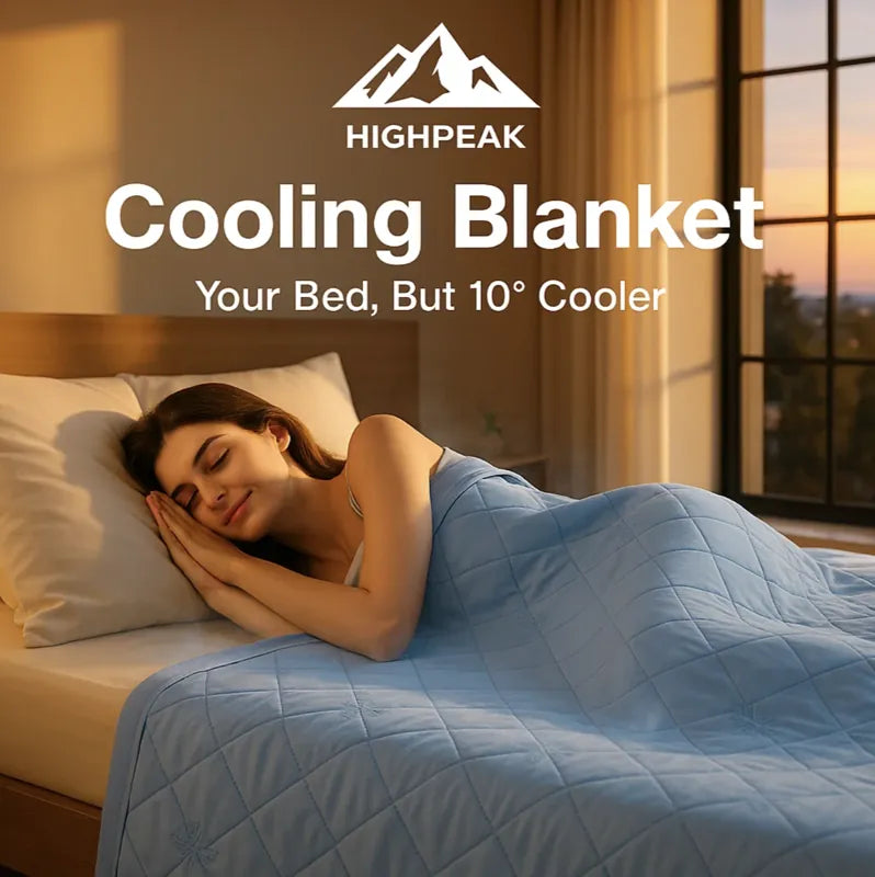 HighPeak Cooling Blanket in light blue on bed with woman sleeping peacefully by sunset window light