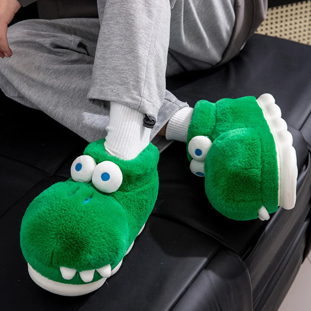 Close-up of crocodile slippers worn with white socks while relaxing on a black couch