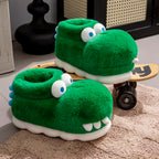 Green crocodile slippers displayed on a beige rug and wooden skateboard