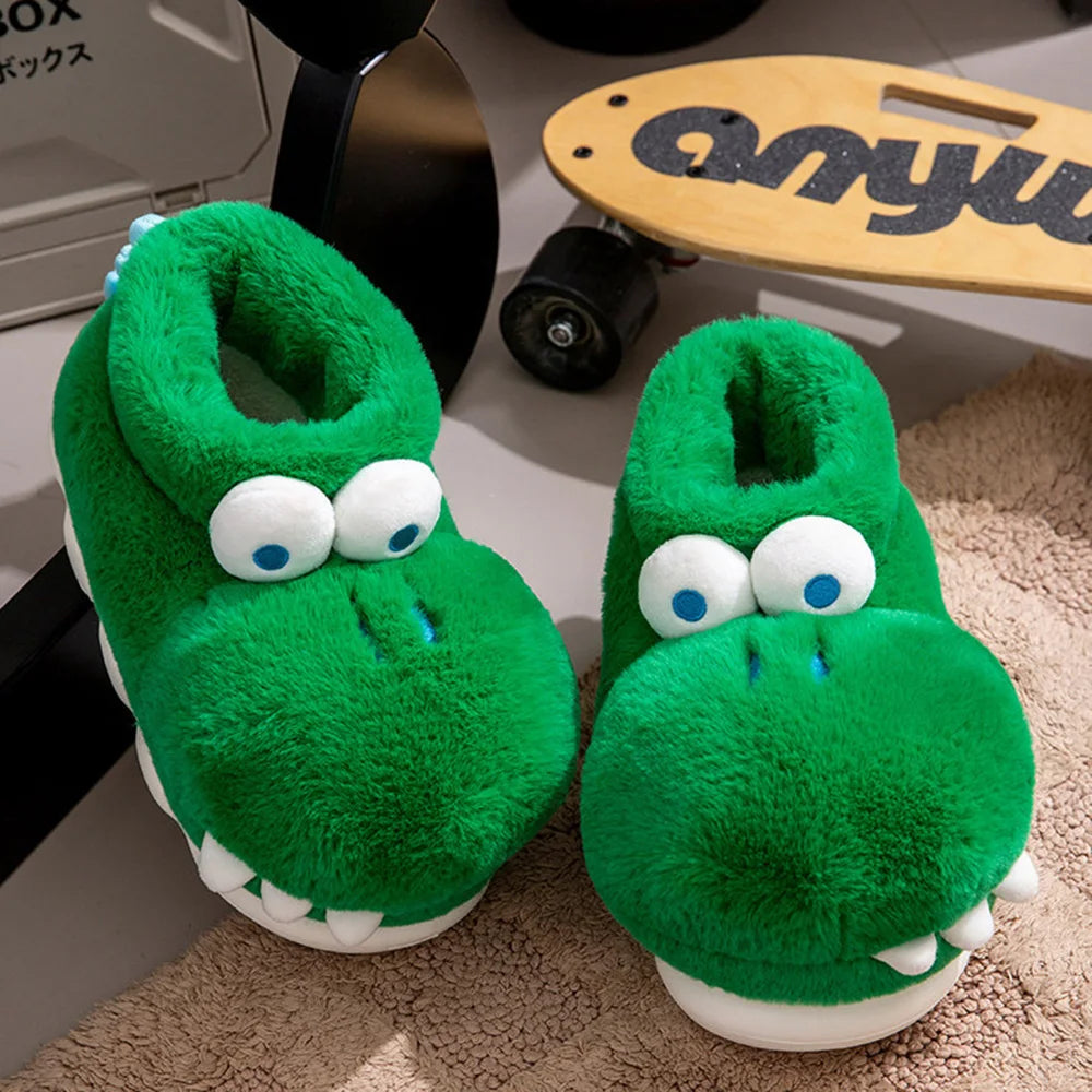 Green Cozy Crocodile Slippers with plush eyes and white teeth on a rug beside a skateboard