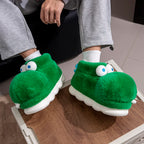 Cozy Crocodile Slippers worn with gray trousers and white socks while seated