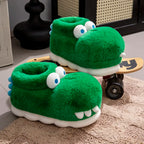 Side profile of plush crocodile slippers on and beside a wooden skateboard