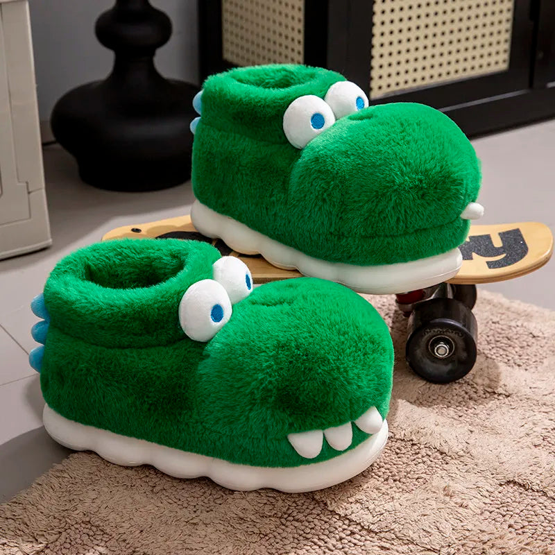 Side profile of plush crocodile slippers on and beside a wooden skateboard