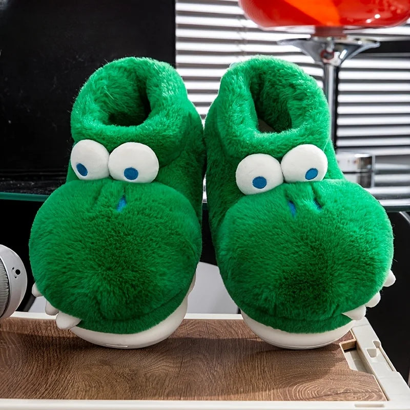 Front view of green crocodile slippers with open plush collars on a wooden surface