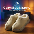 HighPeak CozyGlide Slippers in beige with plush fleece lining and durable sole on wooden floor in warm indoor setting