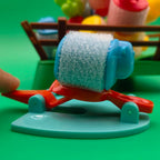 Close-up of a blue sheep on a red springboard with a pale blue base