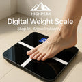 HighPeak Digital Weight Scale in black with white stripes showing a person’s foot on tile floor and LCD display visible