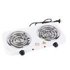 Angled view of white dual burner electric cooktop with silver coils, black control knobs and power cord