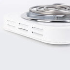 Close-up of side ventilation openings beneath the dual burner electric cooktop's heating coil