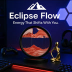 Eclipse Flow™ Dynamic Sand Art in black frame with flowing red sand on a dark desk beside modern decor, HighPeak ambiance