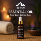 HighPeak Essential Oils lavender bottle with dropper on spa mat near towel and candles for calm ambiance