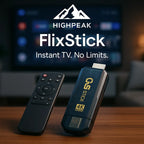 HighPeak FlixStick 4K streaming stick and black remote on wooden table with TV blurred in background