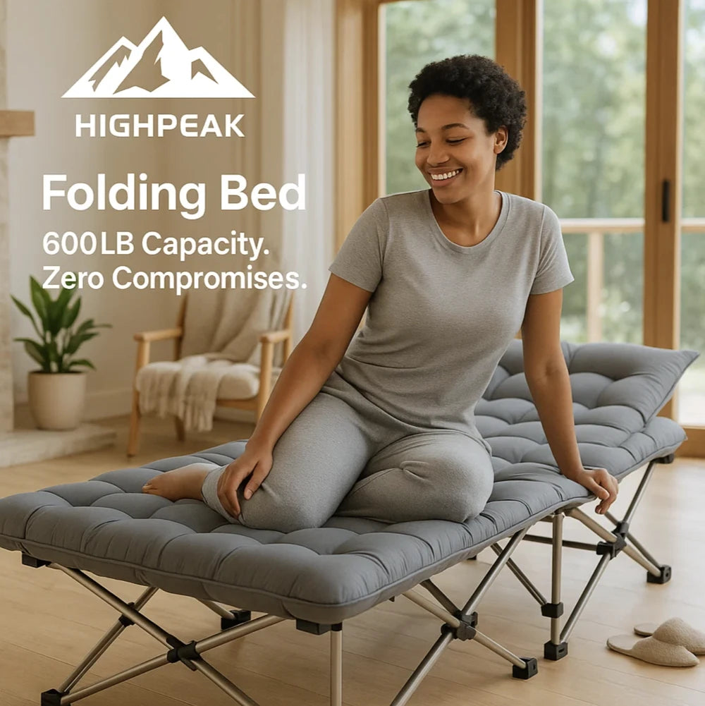 HighPeak Folding Camping Bed in gray with padded mattress, folding steel frame, shown indoors with smiling woman sitting