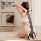 Woman kneeling with the Foot Pedal Resistance Trainer handle behind her shoulders and feet in the loops.