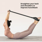 Woman lying on an exercise mat holding the Foot Pedal Resistance Trainer handle with feet in its loops.