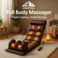 HighPeak 5-in-1 Full Body Massager in brown with heat and vibration zones on floor in cozy living room setting