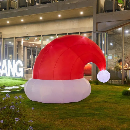 Giant Inflatable Santa Hat illuminated on a lawn at night