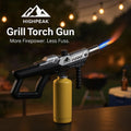 HighPeak Grill Torch Gun with yellow propane tank attached, ignited flame, ideal for BBQ and outdoor use at night