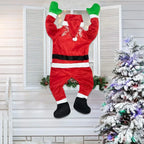 Hanging Santa Claus Decor in a bent-leg pose at a white shuttered window.