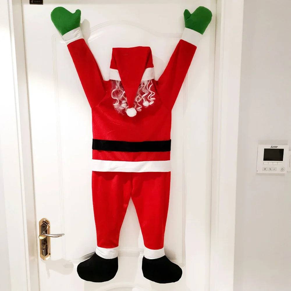 Back view of red hanging Santa decoration with curly white hair on a white door.