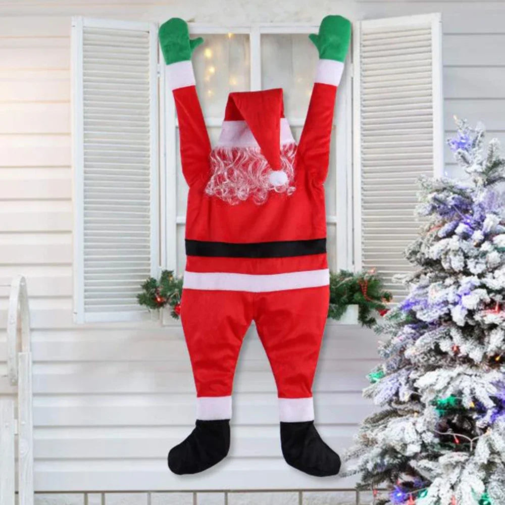 Hanging Santa Claus Decor with straight legs at a white shuttered window beside a decorated tree.