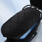 Close-up of the black quilted Heated Motorcycle Seat Pad on a blue scooter seat