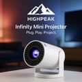 HighPeak VisionHack Projector Bundle with white Infinity Mini Projector on table in cozy, dimly lit living room setting