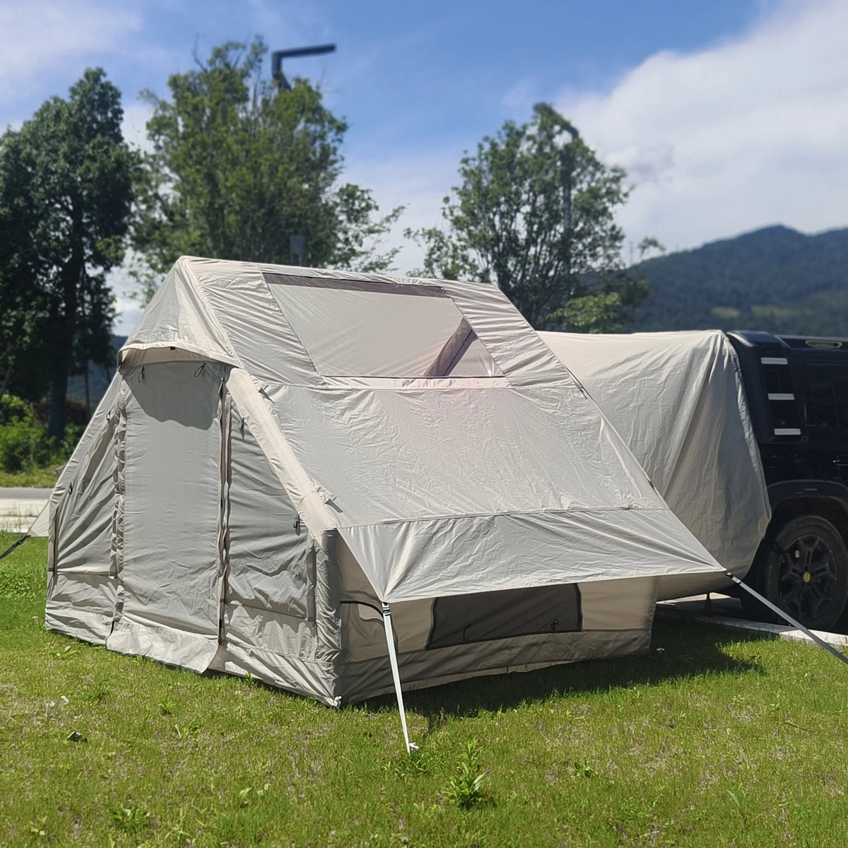 Inflatable Car Camping Tent with its front privacy cover closed and clear upper side panel visible
