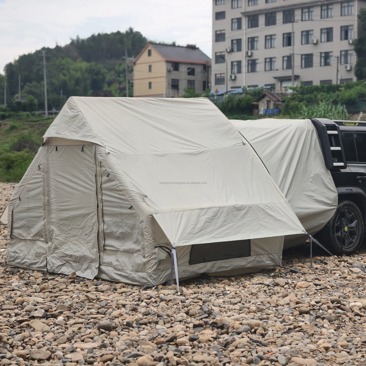 Inflatable Car Camping Tent with door and front window privacy panels closed beside an SUV